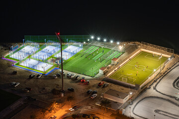 Aerial view of football ground and tennis court at night from Juffair area, Manama, Bahrain