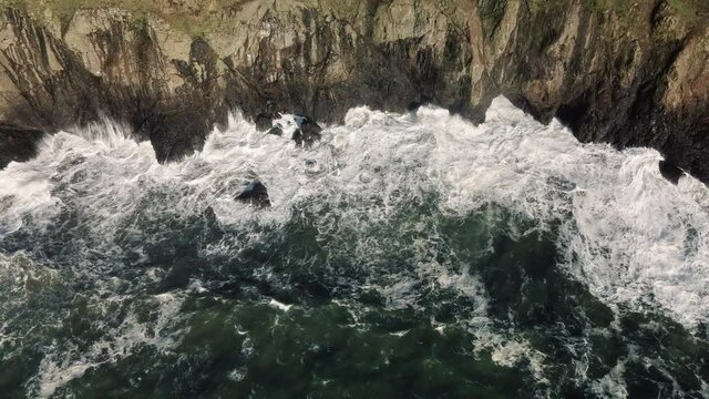Drone Flying Along Washington Coast with Waves Splashing Rocky Cliffs