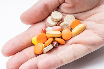 person hold large group different drugs at hand. close up. medication concept