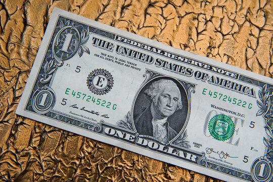 American dollar banknote and bitcoin coin next to a sheet and pen on a gold background. Bank image and commercial photo on gold background.