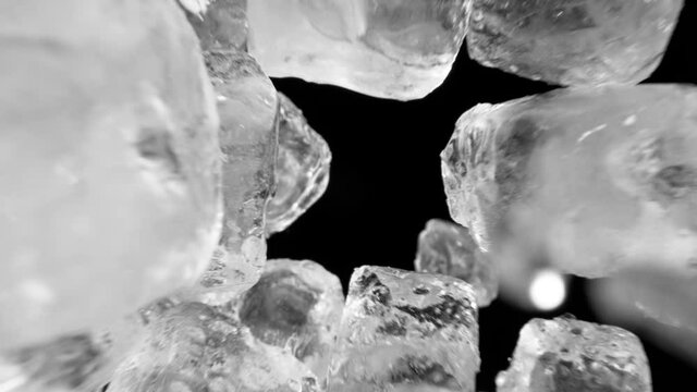 Super slow motion of falling ice cubes isolated on black background. Filmed on high speed cinema camera, 1000 fps.