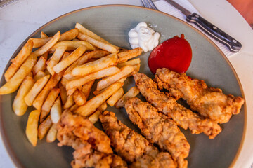 Meal in Dominican Republic. French fries with pechurina (chicken strips)