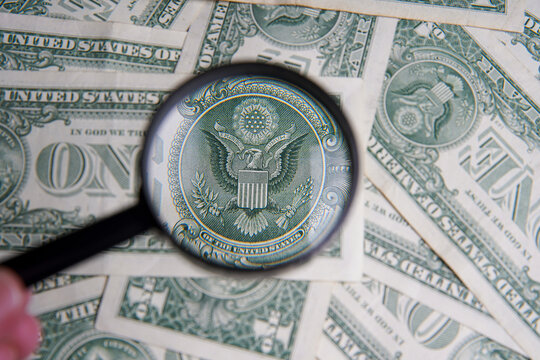 American dollar viewed through a magnifying glass, close up. Bank image and commercial photo background.