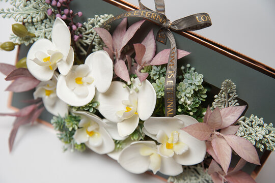 Beautiful phalaenopsis potted orchid flowers on a white background. Concept wedding, mothers day and valentines day background. Small depth of field.