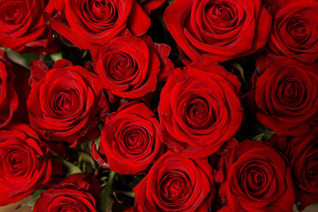 Beautiful bouquet of red roses, seen from above. Spring flowers. Wedding, women's day, mothers day and valentines day background. Selective shallow depth of field.