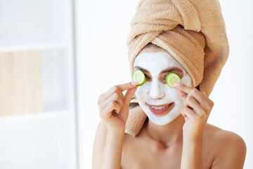 Skin care, woman with beautiful facial skin applying mask on face