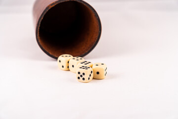 Dice gamble toss with depth of field and a dice cup