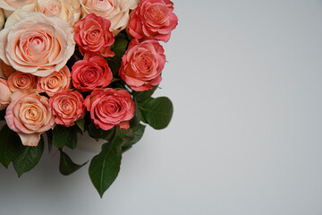 Beautiful white, red, tabby tea rose flowers in a vase, photographed from above on a white table. Spring flowers. Wedding mothers day and valentines day background. Selective small depth of field.