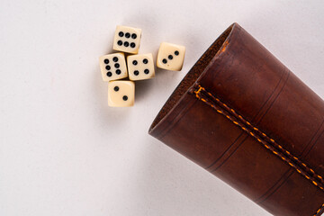 Dice gamble toss with depth of field and a dice cup