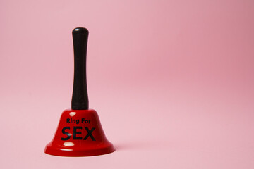 Red bell with sex inscription. Bell ringing for erotic toys. Concept of sex and erotica. For...