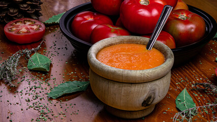 Natural homemade tomato sauce with natural ingredients and a gastronomic style decoration with part of the elaboration ingredients