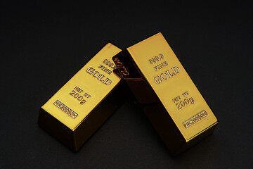 two gold bars on a black background. Shiny precious metals for investments or reserves. Place for text.