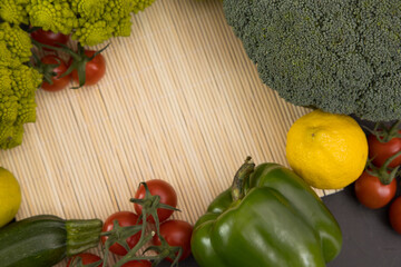 Healthy vegetarian food, fresh green food, green vegetable, romanesco broccoli, pepper, zucchini, avocado, lemon and cherry tomato, free space in your text
