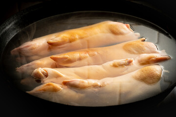 Fresh pork trotters being cooked