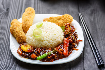 rice with vegetables in sweet and sour sauce and chicken tenderloin