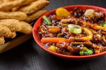 rice with vegetables in sweet and sour sauce and chicken tenderloin