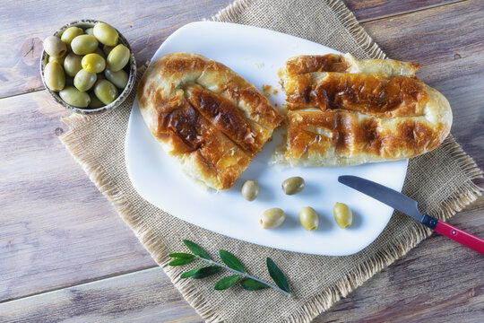 Balkan cuisine. Burek with meat -  popular national dish - in white plate on rustic table. Copy space. Flat lay