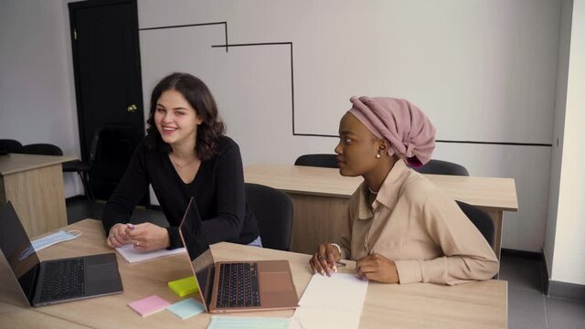 Foreign school private study with a school girl. Teacher explain grammar of native language using laptop. Prepearing to exam with tutor. English, British, German and Poland flags in front.