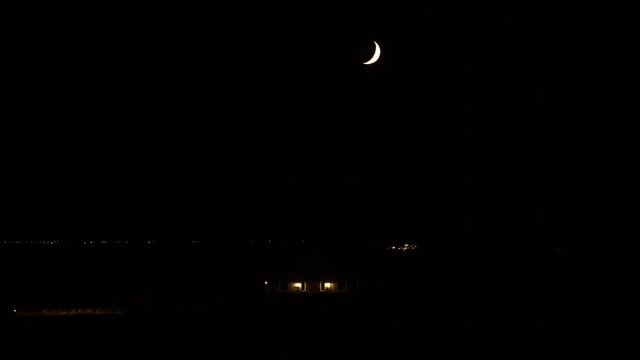 Car parking at country house under cresent moon dark night Iceland