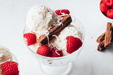 Vanilla Ice Cream Scoops with raspberries and chocolate sticks, easy dessert at home