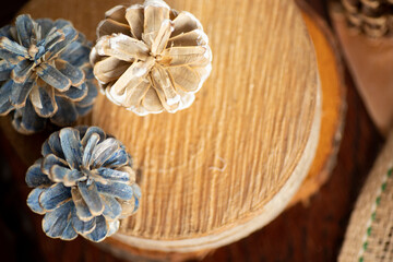 blue and white pine cones on a wooden background.