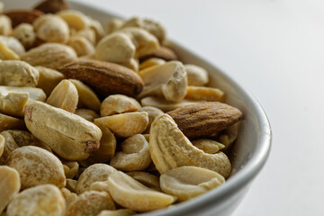 Close-up of nuts in a white bowl.