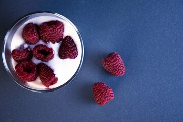 Glass with yogurt and raspberries