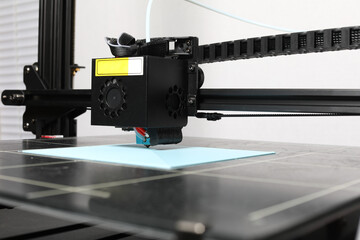 3D printer printing PLA on a grid surface