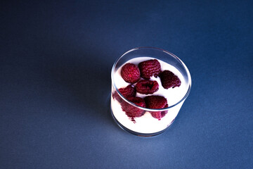Glass with yogurt and raspberries