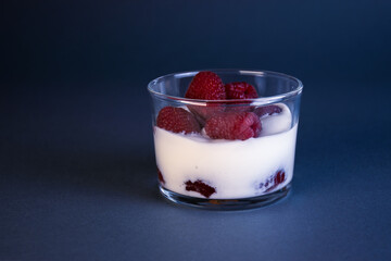 Glass with yogurt and raspberries