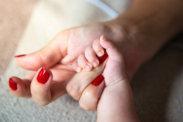 Close up of mother and child hands, love and security