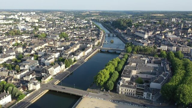 Aerial view of modern cityscape of French town of Laval on banks of Mayenne River in summertime. High quality 4k footage