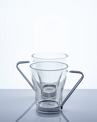 Two transparent tea glasses on a light background