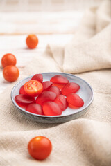Jelly tomato candies on white wooden background. close up, side view, selective focus.