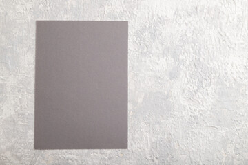 Gray paper business card, mockup on gray concrete background. Blank, flat lay, top view