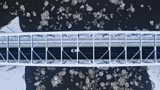 Top down view of river with floe and bridge above