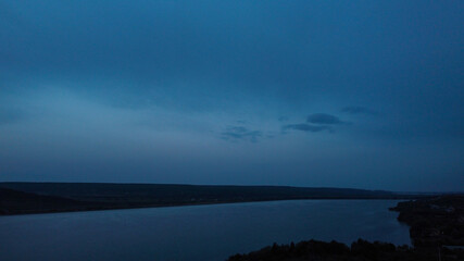 Aerial shot of a sea under the dark blue sky in the evening