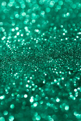Green glitter texture. Festive background. Color sparkles. Abstract Christmas.