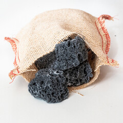 Chunks of sweet coal inside a burlap sack
