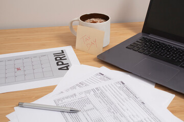 Session to set up bills and bills for tax day at a table with a calculator and a laptop with a tax...