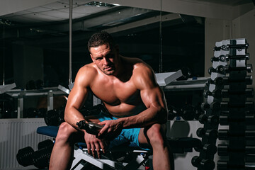 Fototapeta na wymiar Man drink water in gym. Healthy sport lifestyle. Sportsman resting after training.