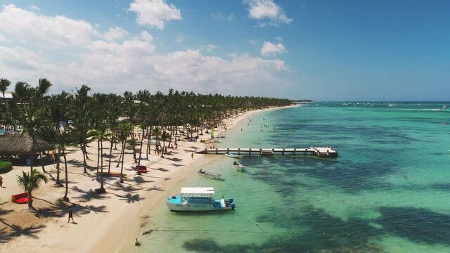 Aerial 4K video of Punta Cana beach resort, palm trees and turquoise caribbean sea. Getaway tropical destination in Dominican Republic