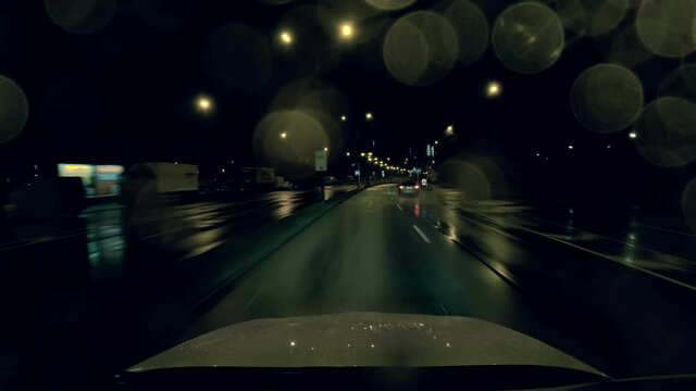 Highspeed in the city night - driving by car through wet tunnels in the Tenet film look colors, tile and orange. Urban acceleration at the fastlane in 4K.