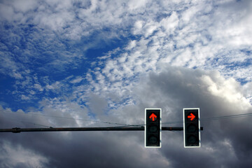Crossroad traffic lights on the sky background.