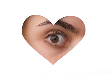 Eye through paper. Ophthalmology. Closeup eyes. Heart shaped hole.