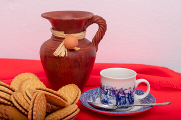 breakfast with chocolate cookies, cup of coffee and vase.
