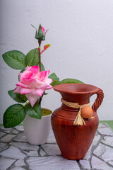 vase with pink flowers and green leaf.
