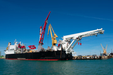 Cranes to repair boats in the bay of Cadiz capital, Andalusia. Spain. Europe. February 14, 2021
