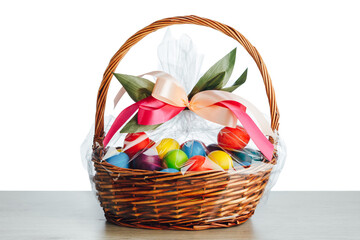 Fototapeta na wymiar Easter gift basket with multicolor eggs, white background