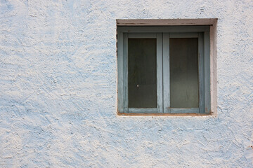 Window in blue textured wall